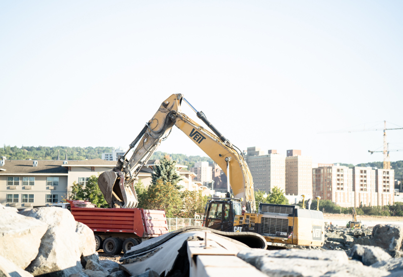 Excavator Dumping Rocks On Veit's Dump Truck