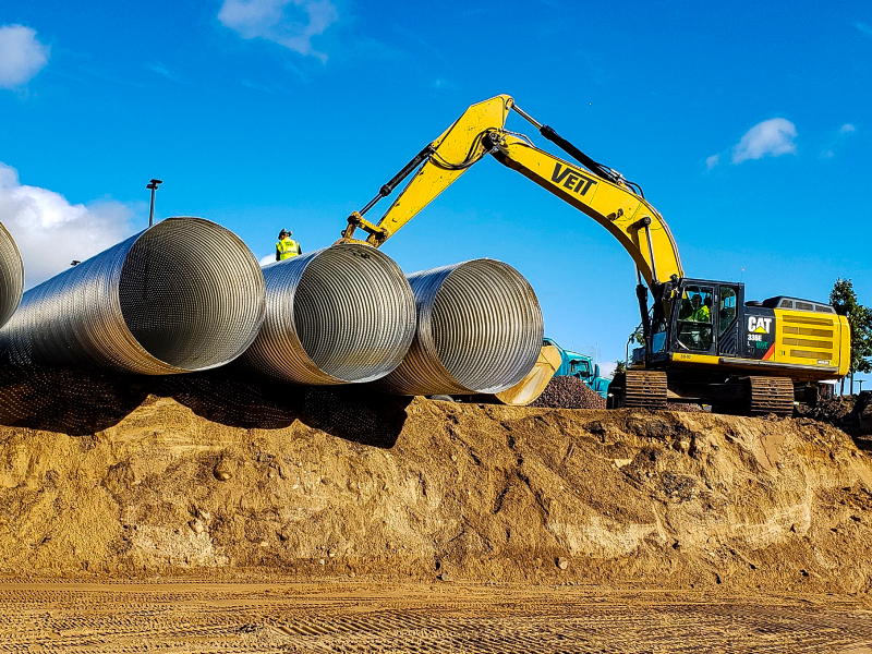 CAT Equipment With 3 Large Metal Cylinders at a Utility Project