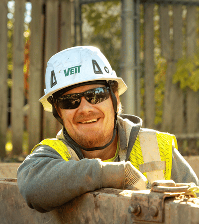 Man smiling in trench box