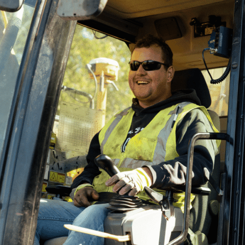 Man smiling while operating heavy equipment
