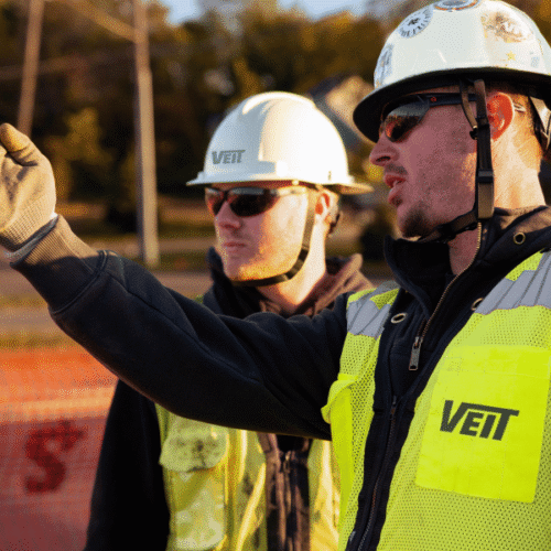 Two men discussing project operations on Veit jobsite