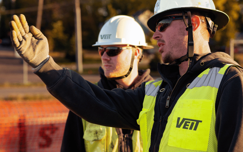 Two men discussing project operations on Veit jobsite