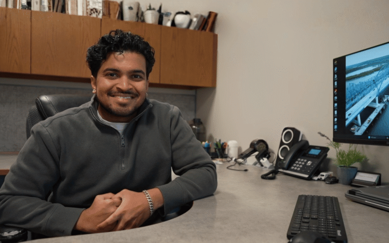 Project Manager Smiling at His Desk