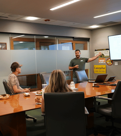 Group of interns listening to Demolition leader during a lunch n learn