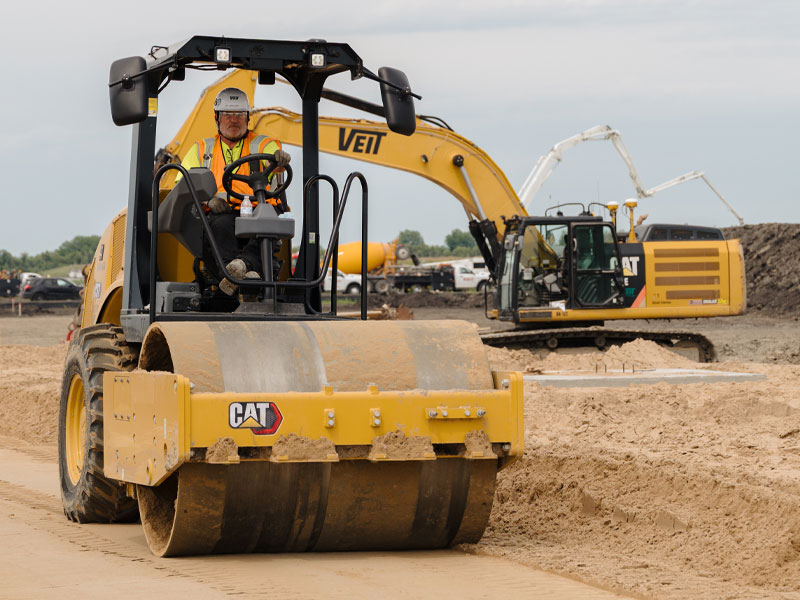 Veit employee driving equipment on earthwork construction site